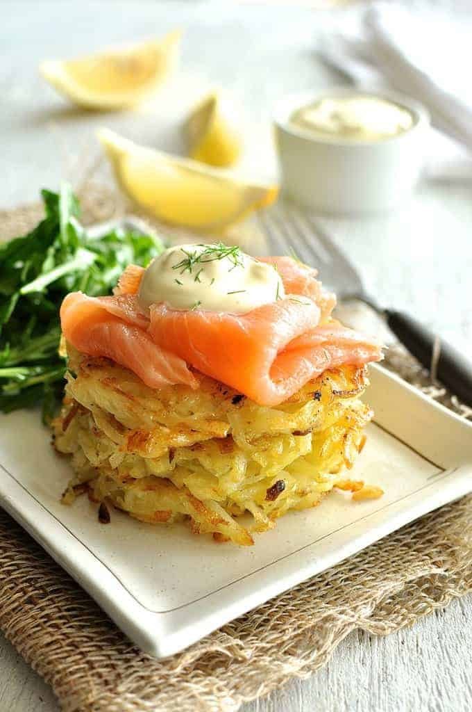 Smoked Salmon Potato Rosti Stack with a rocket salad and lemon wedges on the side