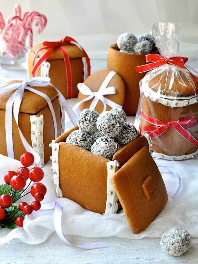 Festive spread of Gingerbread Boxes and Mason Jars tied with ribbons and filled with chocolate truffle balls.