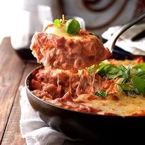 A scoop of Creamy Tomato Pasta Bake With Chicken