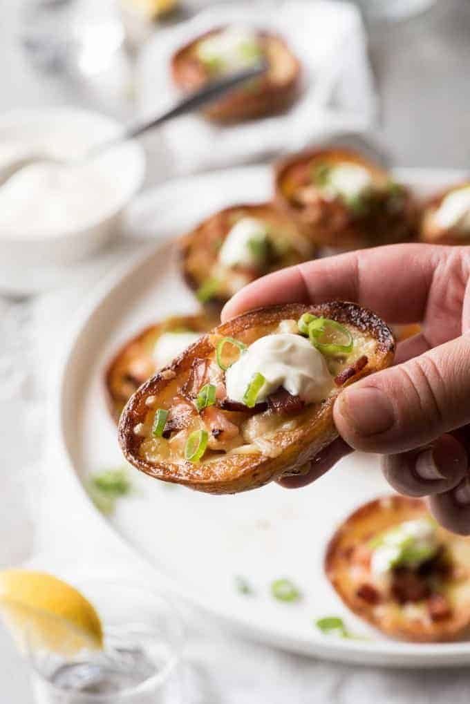 Hand holding a Cheese & Bacon Potato Skin