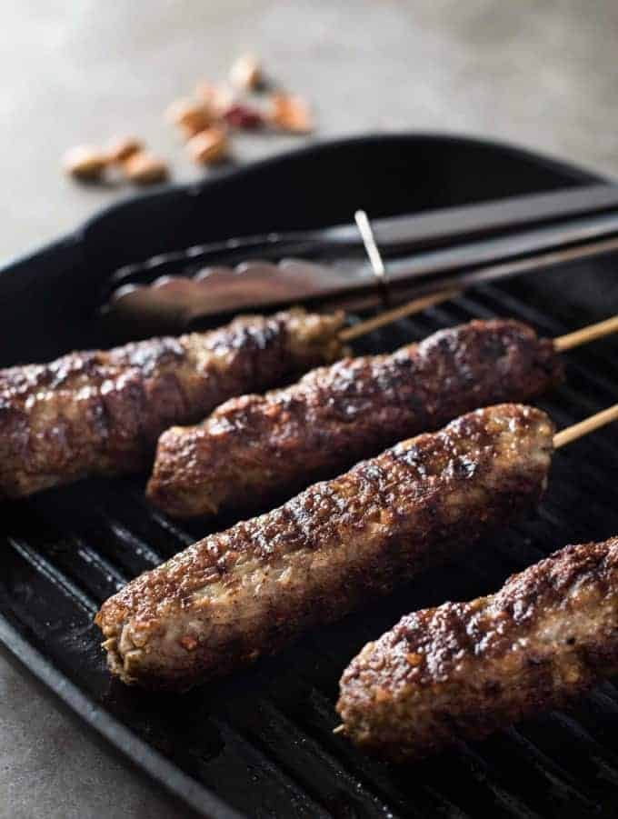 Lamb kofta kebabs grilling in a griddle pan