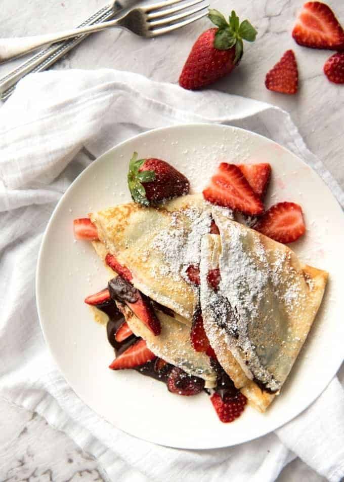 Nutella Crepes with Strawberries - The batter is a 10 second job when made with a blender! And you do not need a crepe pan, just a skillet! recipetineats.com