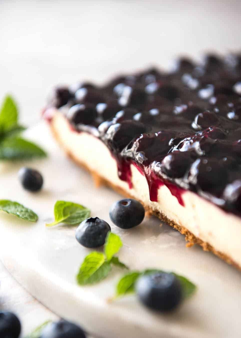 Easy and fast No Bake Blueberry Cheesecake Bars - creamy cheesecake with a gorgeous fresh blueberry sauce topping! www.recipetineats.com