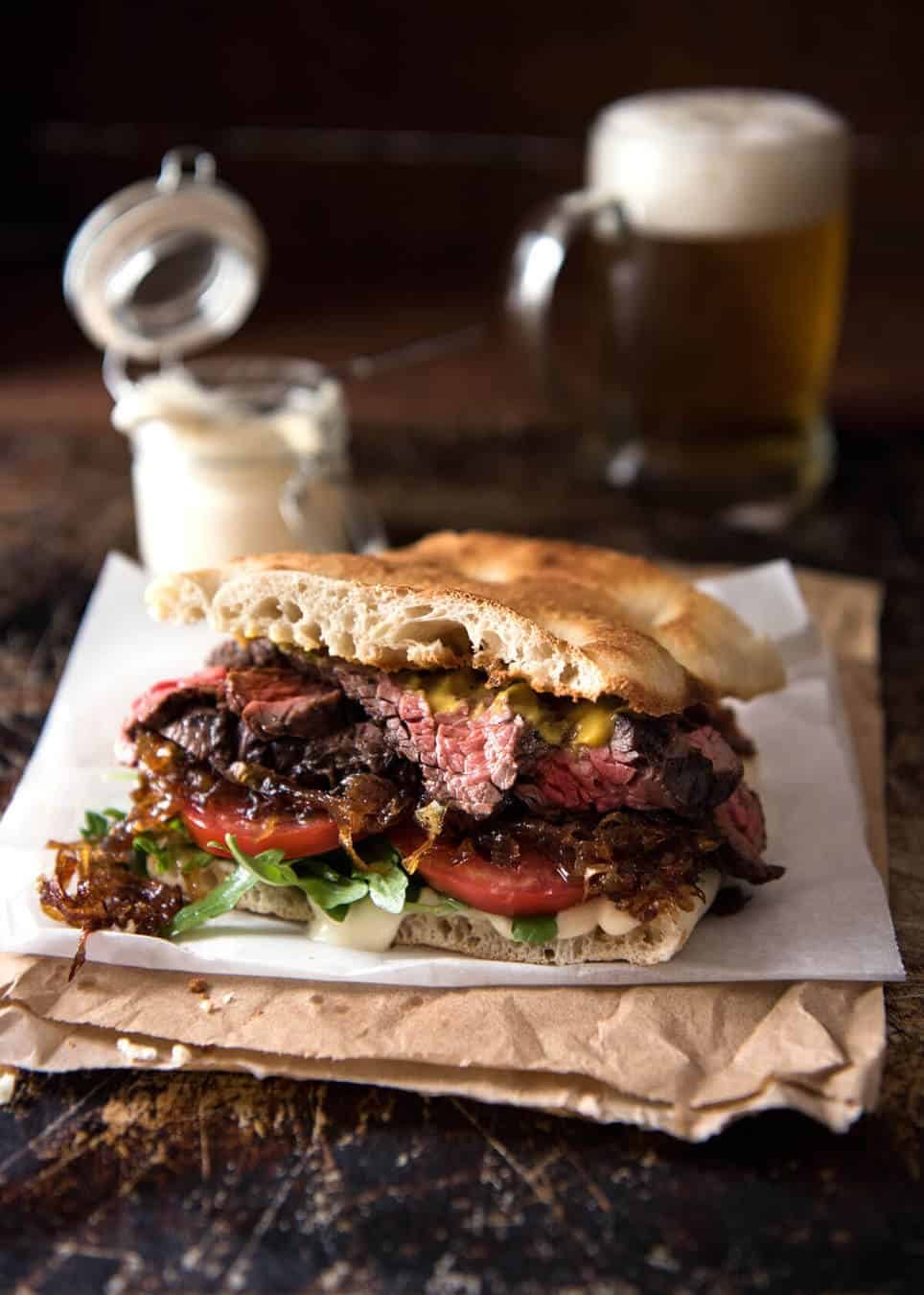 A juicy Steak Sandwich loaded with tender slices of steak, caramelised onion, garlic aioli, lettuce, tomato and mustard. www.recipetineats.com