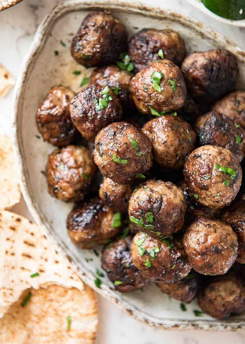 Soft, juicy, beautifully flavoured GREEK MEATBALLS! Serve as an appetiser with tzatziki, main with Greek Salad or make wraps! recipetineats.com