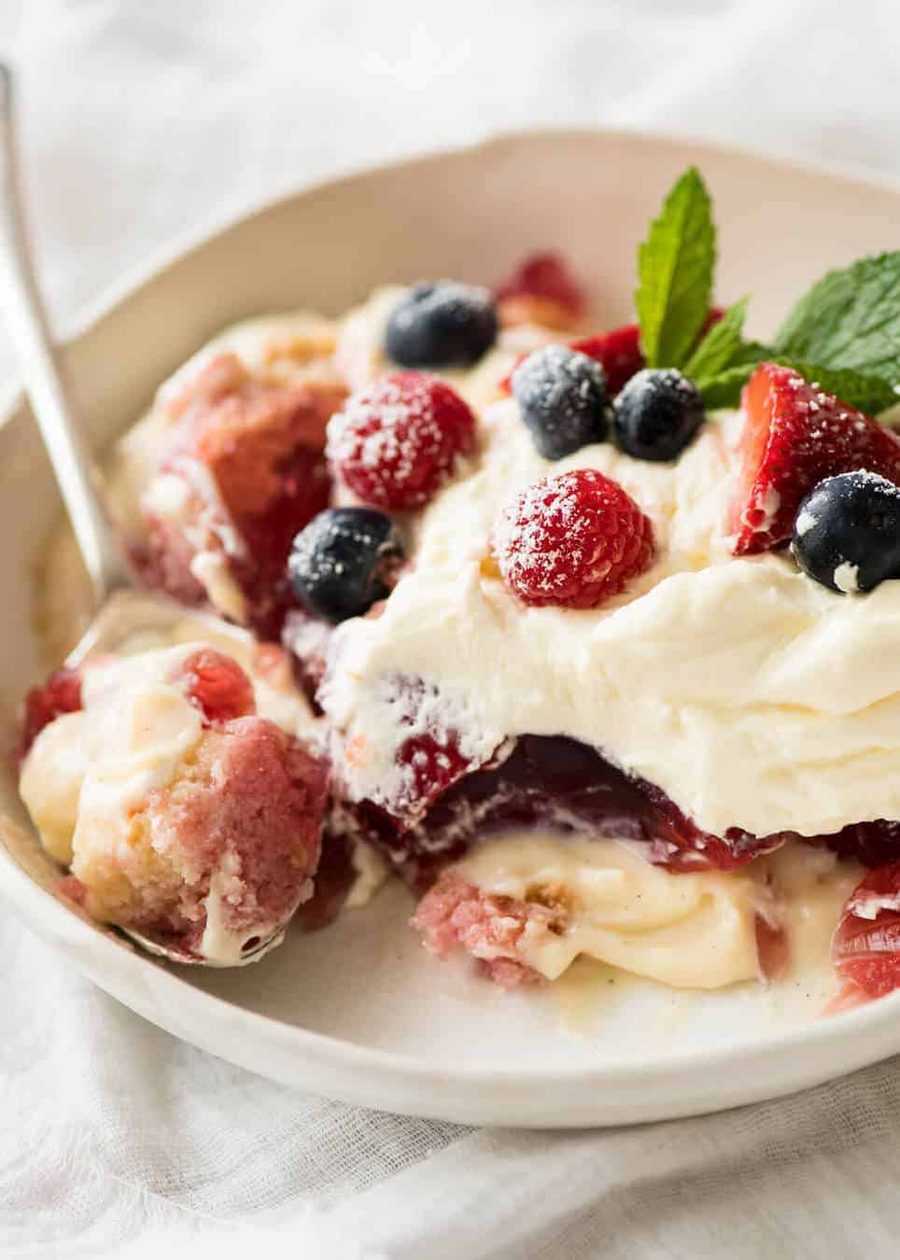 Layers of Cranberry Jelly and custard, and piled high with whipped cream and fruit, this Christmas Trifle will brighten any table! recipetineats.com