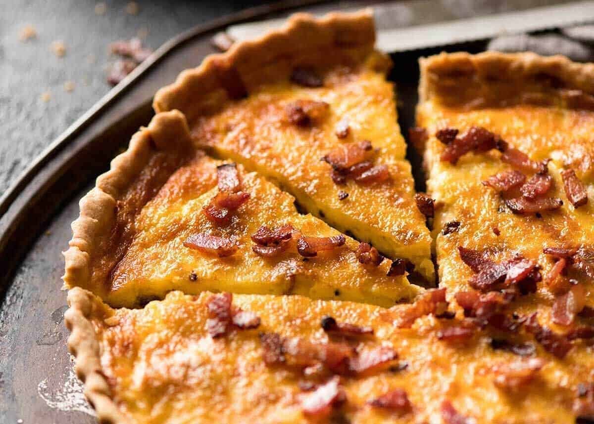 Photo of quiche lorraine on a rustic metal serving tray