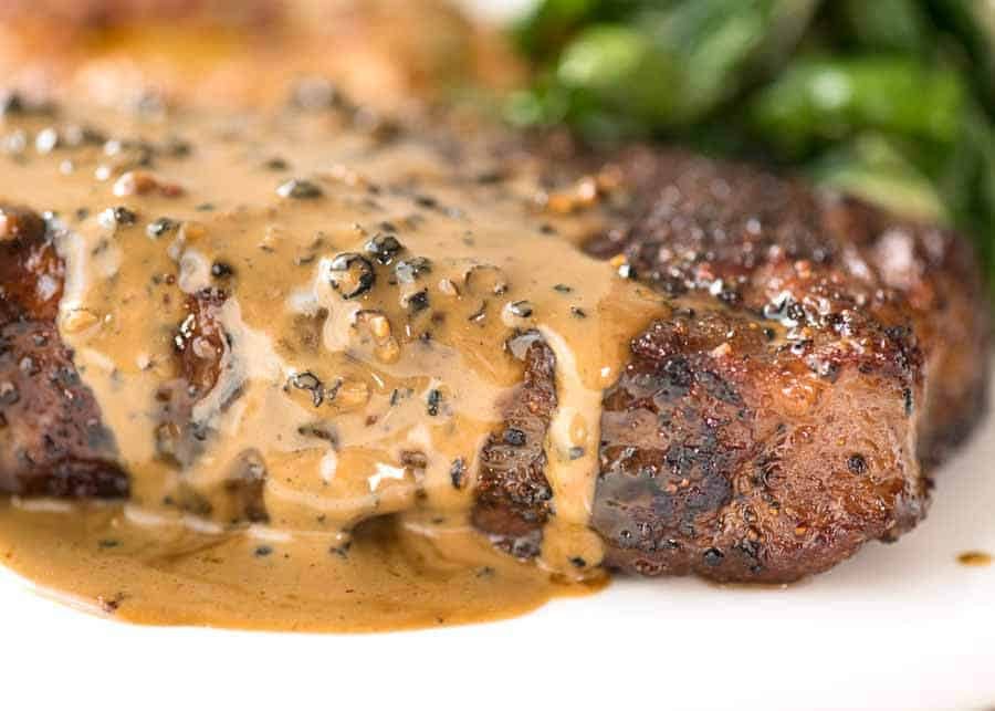 Close up of Creamy Peppercorn Sauce dripping down the side of steak