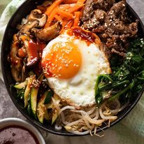 Overhead photo of Bibimbap, Korean Rice Bowl, ready to be eaten