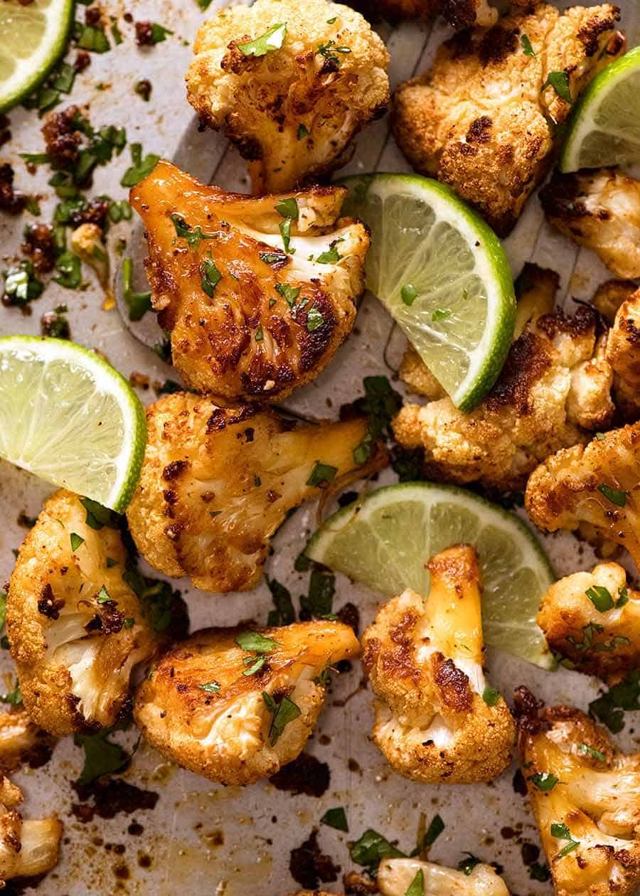 Close up of Chipotle Lime Roasted Cauliflower on a sheet pan, fresh out of the oven
