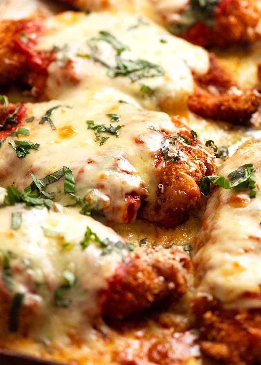 Close up of tray of Chicken Parmigiana (Chicken Parmesan), fresh out of the oven