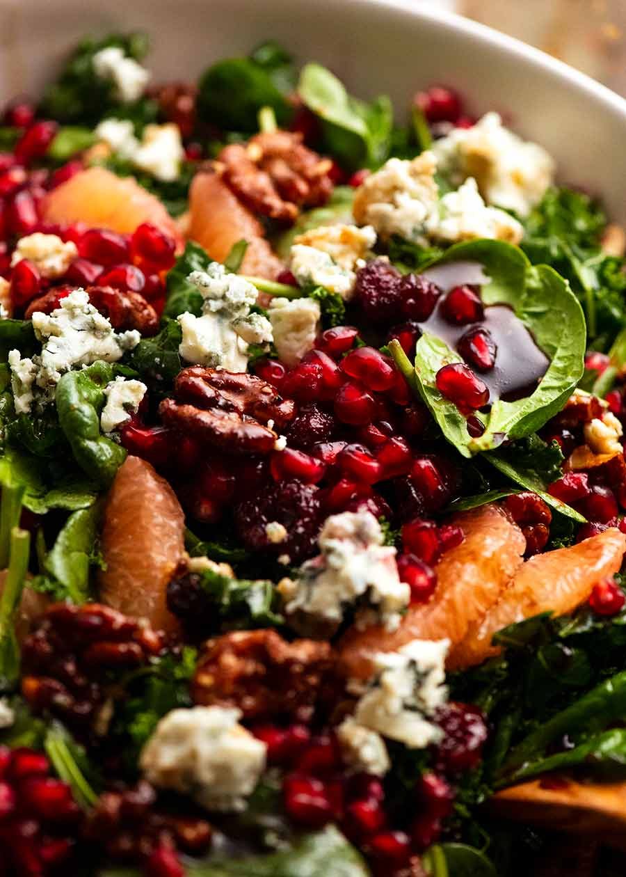 Close up of Pomegranate Salad with Baby spinach kale and honey candied walnuts
