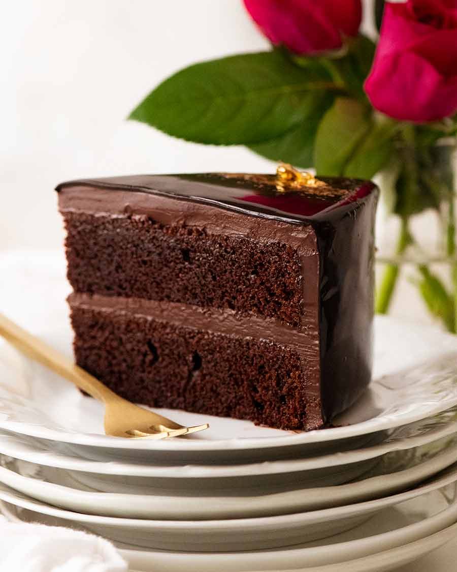 Slice of Chocolate Mirror Glaze Cake ready to be eaten