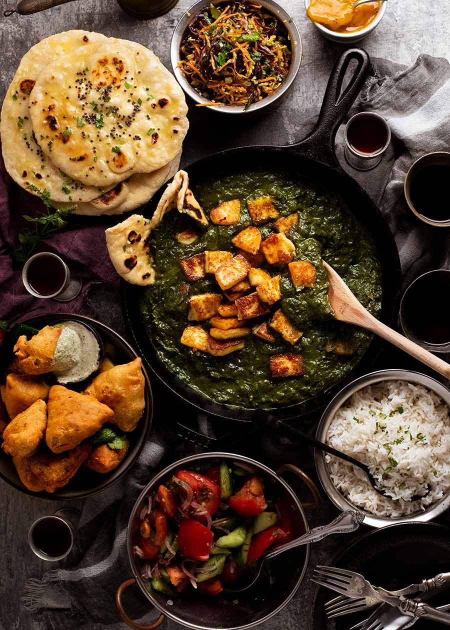 Indian feast menu - Palak Paneer, Basmati rice, homemade naan, samosas and Cabbage Thoran side salad