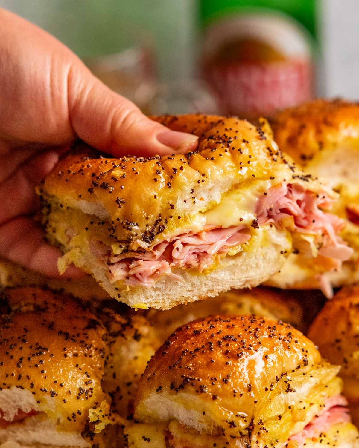 Hand holding Hot Ham and Cheese Sliders