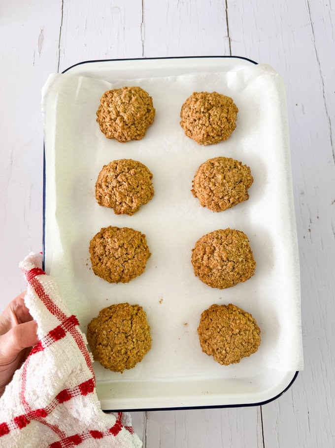 Cookies arranged on a baking tray fresh out of the oven.